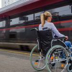 disabled woman waiting to board a train