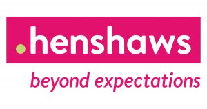 a logo consisting of a pink box with white text that reads Henshaws. Text below reads Beyond expectations